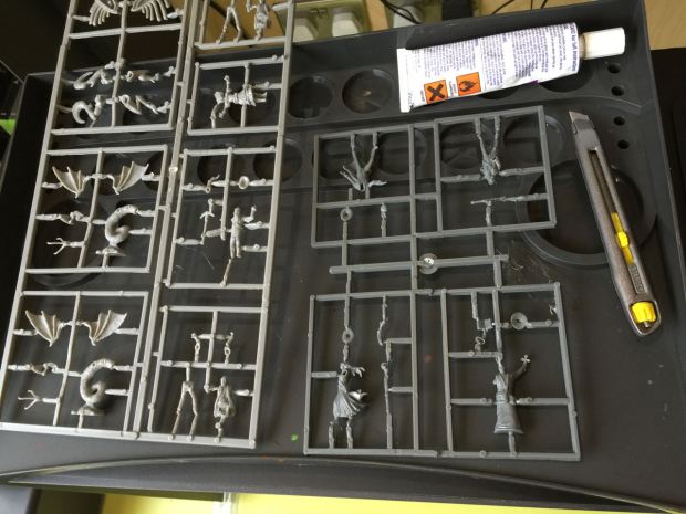 You have to cut the parts of each figure out of the frame and glue them together.