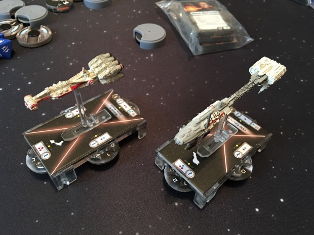 The two rebel ships on their bases. Ships can fire in all directions, so they have four firing arcs.