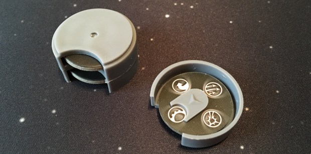 The command dials. You set the dial you your chosen command, then put it on the bottom of the stack. Each turn you do the command on the top of the stack.