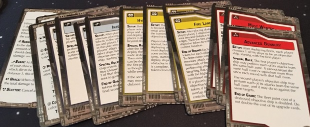 The objective cards. Most of these have rules for how to score points in the game. There are a variety of different types including 'capture the flag' kind of games.